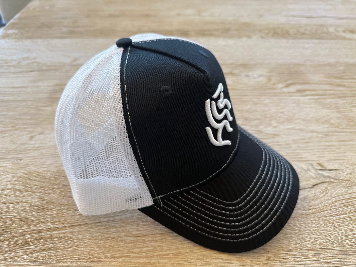 American Reins Puff Embroidery Trucker Hat - Black + White